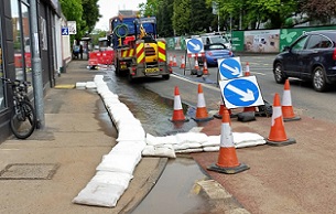 FloodSax diverting floodwater from a burst water main away from a supermarket and down a drain