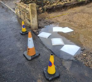FloodSax soaking up a pool of water on a sodden driveway